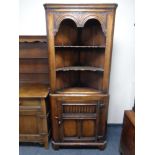 A Titchmarsh & Goodwin oak corner cabinet retailed by Chapman's