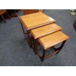 A nest of three mid 20th century teak G plan tables