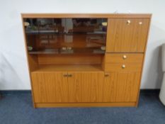 A teak effect cocktail display sideboard