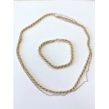 An 18ct gold two-tone rope twist necklace and matching bracelet, lengths 50cm and 20cm respectively.