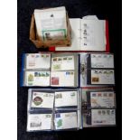 A box containing several folders of first day covers