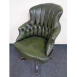 A green buttoned leather swivel high back desk chair