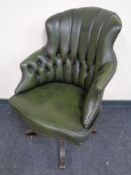 A green buttoned leather swivel high back desk chair