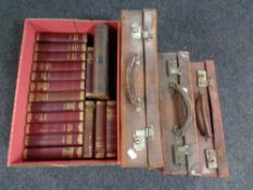 Three vintage leather cases together with a set of sixteen volumes of Dickens,