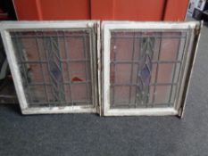 A pair of antique stained leaded glass windows in original frames (as found)