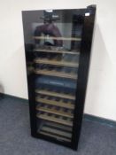 A Haier glass door wine fridge, height 126 cm.