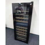 A Haier glass door wine fridge, height 126 cm.