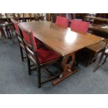 An oak refectory dining table together with a set of four chairs in studded upholstery