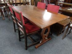 An oak refectory dining table together with a set of four chairs in studded upholstery