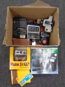 A box containing vintage cameras and camera packs