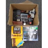 A box containing vintage cameras and camera packs