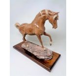 A Heredities pottery figure of a horse on wooden plinth