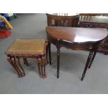 A nest of three leather and glass topped tables in a mahogany finish together with a hall table on