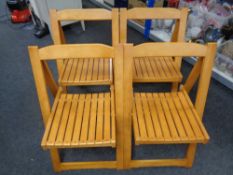 A set of four folding kitchen chairs