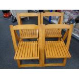 A set of four folding kitchen chairs