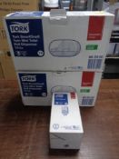 Two Tork twin mini toilet roll dispensers together with a Tork liquid soap dispenser,