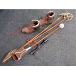 A pair of vintage bamboo ski poles, a pair of ski boots,
