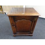 A Titchmarsh and Goodwin oak single door low cabinet