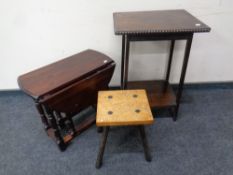 A stained pine drop leaf occasional table together with a milking stool and a further occasional