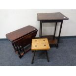 A stained pine drop leaf occasional table together with a milking stool and a further occasional