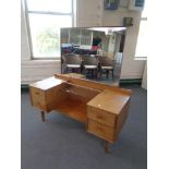 A 20th century teak Handcraft Quality Furniture sunk centre dressing table