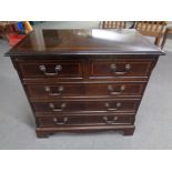 A reproduction mahogany effect five drawer chest