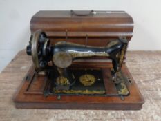 A vintage Gloria hand sewing machine in case