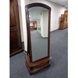 A mahogany effect cheval mirror fitted a drawer.