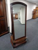 A mahogany effect cheval mirror fitted a drawer.