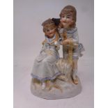A Bisque figure of two girls