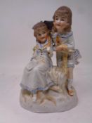 A Bisque figure of two girls