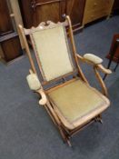 An Edwardian beech folding rocking chair