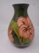 A Moorcroft Hibiscus patterned vase, height 21 cm.