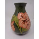 A Moorcroft Hibiscus patterned vase, height 21 cm.