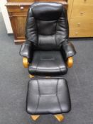 A black leather armchair and matching footstool