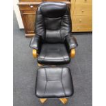 A black leather armchair and matching footstool