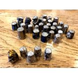 A collection of thirty-four thimbles, including at least five silver examples,