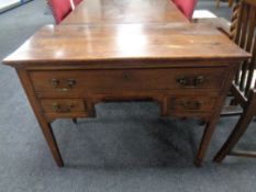 A George III elm kneehole table fitted three drawers