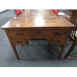 A George III elm kneehole table fitted three drawers