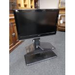 A Toshiba Regza 37" LCD TV with remote on stand