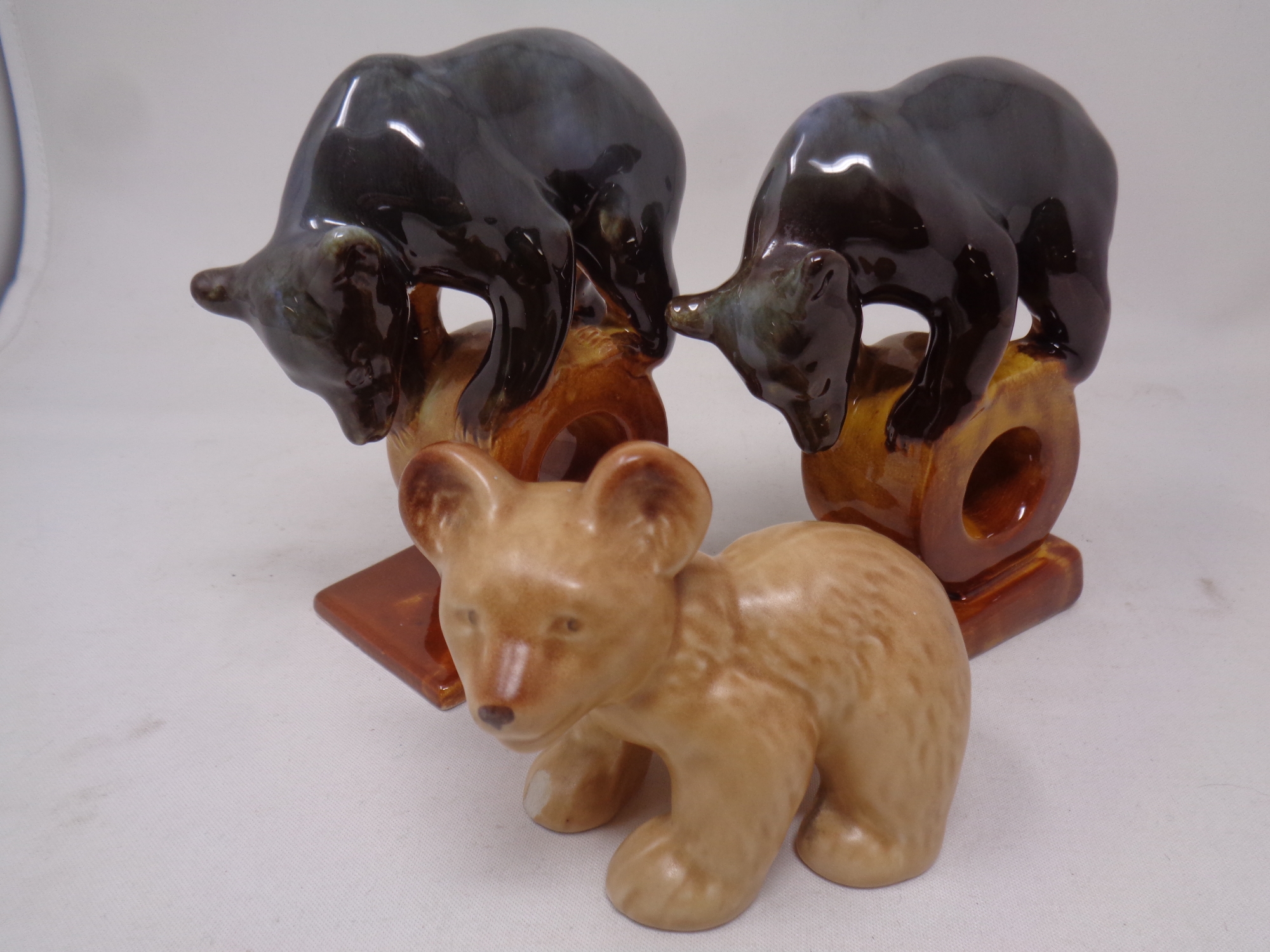 A pair of mid 20th century Russian Konakovo bear figures together with a further Sylvac figure of a