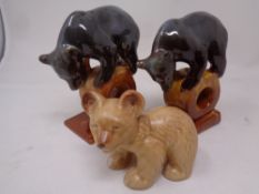 A pair of mid 20th century Russian Konakovo bear figures together with a further Sylvac figure of a