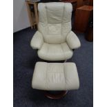 A Stressless cream leather swivel adjustable armchair with stool