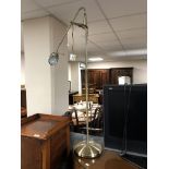 An adjustable standard reading lamp, in antique brass effect finish.