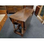 A Titchmarsh & Goodwin oak drop leaf table retailed by Chapman's