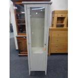 A contemporary pine single door display cabinet