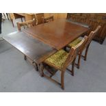 A six piece oak dining room suite comprising of buffet back sideboard,