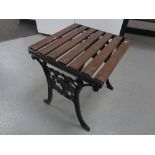 A cast iron wooden slatted patio occasional table, width 45 cm.