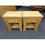 A pair of contemporary oak bedside tables fitted a drawer