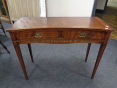 A Regency style inlaid mahogany inverted bow front side table fitted two drawers